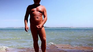 Jonathan outside strips and wanks his soft uncut cock till erect horny proudly showing out in grassy area on a sunny day