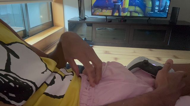 Twink jerking off until he cums while playing video games.